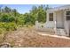 White back porch and gardens with potted plants on a partially bare lot at 333 N Kentucky Ave, Deland, FL 32724