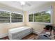 Cozy bedroom with hardwood floors, natural light streaming through windows overlooking verdant scenery at 333 N Kentucky Ave, Deland, FL 32724