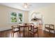 Comfortable dining room with hardwood floors, a window view, arched entry to kitchen with breakfast bar at 333 N Kentucky Ave, Deland, FL 32724