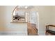 A bright, airy kitchen with granite countertops, white cabinets, and an arched doorway to the dining room at 333 N Kentucky Ave, Deland, FL 32724