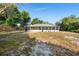 Expansive backyard featuring a screened lanai and a privacy fence, perfect for outdoor entertaining and relaxation at 333 Redwood Ave, Orange City, FL 32763