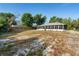 Spacious backyard with a long screened-in porch, patio, and wood fencing at 333 Redwood Ave, Orange City, FL 32763