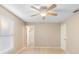 Bright bedroom with a ceiling fan, neutral walls, white trim, and access to an attached bathroom at 333 Redwood Ave, Orange City, FL 32763