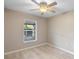 Bright bedroom features a ceiling fan, neutral paint, and a window that allows natural light to illuminate the space at 333 Redwood Ave, Orange City, FL 32763