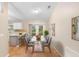 Bright dining area features hardwood floors, modern glass table, and sliding glass doors at 333 Redwood Ave, Orange City, FL 32763