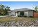 Charming single-story home with a well-maintained lawn, mature trees, and an attached garage for convenience at 333 Redwood Ave, Orange City, FL 32763