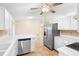 Modern kitchen with stainless steel appliances, white cabinets, and tile floors at 333 Redwood Ave, Orange City, FL 32763
