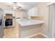 Well-lit kitchen with white cabinets, stainless steel appliances, and a mosaic tile backsplash at 333 Redwood Ave, Orange City, FL 32763