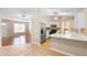 Spacious kitchen opens to living area, featuring stainless steel appliances and eat-in counter at 333 Redwood Ave, Orange City, FL 32763