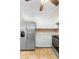 Updated kitchen with stainless steel refrigerator, white cabinetry, and tile backsplash at 333 Redwood Ave, Orange City, FL 32763