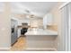 Functional kitchen with white cabinets, tile floors, stainless fridge, and eat-in counter at 333 Redwood Ave, Orange City, FL 32763