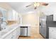 Bright kitchen with stainless steel appliances, white cabinetry, and tile flooring at 333 Redwood Ave, Orange City, FL 32763