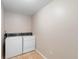 Functional laundry room featuring a washer and dryer set, tile flooring, and clean white walls at 333 Redwood Ave, Orange City, FL 32763