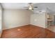 Spacious living room featuring wood floors, a ceiling fan, and neutral paint, creating a welcoming atmosphere at 333 Redwood Ave, Orange City, FL 32763