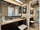 Bathroom vanity featuring granite countertops, dual mirrors, and ample cabinet storage space at 400 Taylorville St, Deltona, FL 32725