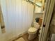 Cozy bathroom showcasing a floral-patterned shower curtain and compact fixtures at 400 Taylorville St, Deltona, FL 32725