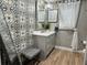 Stylish bathroom featuring decorative wall tiles, marble countertop, decorative mirror, and modern fixtures at 400 Taylorville St, Deltona, FL 32725
