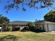 Beautiful single-story home with lush landscaping, including a palm tree and flowering bushes at 400 Taylorville St, Deltona, FL 32725
