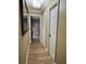 Hallway leading to a bedroom and bathroom, featuring tile floors and neutral wall color at 400 Taylorville St, Deltona, FL 32725