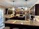 Modern kitchen featuring granite countertops, stainless steel appliances, and a center island with wine storage at 400 Taylorville St, Deltona, FL 32725