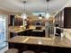 Modern kitchen featuring granite countertops, stainless steel appliances, and a center island with wine storage at 400 Taylorville St, Deltona, FL 32725