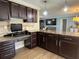 Modern kitchen featuring granite countertops, stainless steel appliances, and a center island with wine storage at 400 Taylorville St, Deltona, FL 32725