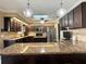 Modern kitchen featuring granite countertops, stainless steel appliances, and a center island with wine storage at 400 Taylorville St, Deltona, FL 32725