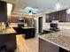 Modern kitchen featuring granite countertops, stainless steel appliances, and a center island with wine storage at 400 Taylorville St, Deltona, FL 32725