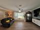 Inviting living room features a bay window seat, decorative wall art, and a modern entertainment center at 400 Taylorville St, Deltona, FL 32725