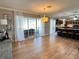 Open-concept living and kitchen area boasts tile flooring, sliding glass doors, and a breakfast bar at 400 Taylorville St, Deltona, FL 32725