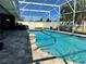 Inviting pool area featuring a pool, lounge chairs, and well-maintained brick pavers at 400 Taylorville St, Deltona, FL 32725