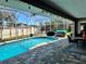 Backyard features a sparkling pool, covered patio, and well-maintained landscaping at 400 Taylorville St, Deltona, FL 32725