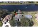 Aerial view of home near a scenic lake with a pool, mature trees, and well-maintained landscaping at 41 Ormond Green Blvd, Ormond Beach, FL 32174