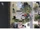 Aerial view of a home near a lake with a pool, mature trees and circular drive near a neighborhood street at 41 Ormond Green Blvd, Ormond Beach, FL 32174