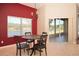 Bright dining area featuring a round table, stylish chandelier, and serene lake views through the window at 41 Ormond Green Blvd, Ormond Beach, FL 32174