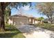 Charming single-story home with a two-car garage, well-maintained lawn, and mature trees offering shade at 41 Ormond Green Blvd, Ormond Beach, FL 32174