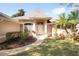 Inviting front entrance with landscaped garden beds, walkway, and a covered entryway with elegant architectural details at 41 Ormond Green Blvd, Ormond Beach, FL 32174
