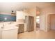 Well-lit kitchen featuring white cabinets, stainless steel appliances, and tile flooring at 41 Ormond Green Blvd, Ormond Beach, FL 32174
