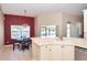 A partial view of the kitchen and dining area, with a red accent wall, chandelier, and scenic backyard at 41 Ormond Green Blvd, Ormond Beach, FL 32174
