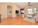 Open-concept living room with hardwood floors, a ceiling fan, and a view of the screened-in patio and backyard at 41 Ormond Green Blvd, Ormond Beach, FL 32174