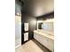 Elegant bathroom featuring a double vanity, sleek lighting, and a tiled shower at 4133 Gilford Cir, Ormond Beach, FL 32174