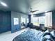 Spacious bedroom features dark blue walls, fan, and large window for natural light at 4133 Gilford Cir, Ormond Beach, FL 32174