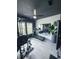 Home gym with treadmill, weight machine, mirrored wall and plenty of natural light at 4133 Gilford Cir, Ormond Beach, FL 32174