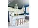 Bright, open kitchen featuring a large island, stainless appliances, and modern pendant lighting at 4133 Gilford Cir, Ormond Beach, FL 32174