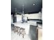 Bright, modern kitchen with a large island, stainless appliances, and designer pendant lights at 4133 Gilford Cir, Ormond Beach, FL 32174