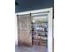 Walk-in pantry with custom shelving, sliding barn door, and ample storage space at 4133 Gilford Cir, Ormond Beach, FL 32174