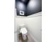Modern powder room with a sleek toilet and a dark accent wall at 4133 Gilford Cir, Ormond Beach, FL 32174