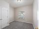This bedroom features neutral decor and carpeted floor, with a bright window offering natural light at 417 Victoria Hills Dr, Deland, FL 32724