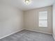 Simple bedroom with neutral carpet, window and paint at 417 Victoria Hills Dr, Deland, FL 32724
