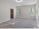 Bright bedroom with plush gray carpeting, two windows and access to a walk-in closet at 417 Victoria Hills Dr, Deland, FL 32724